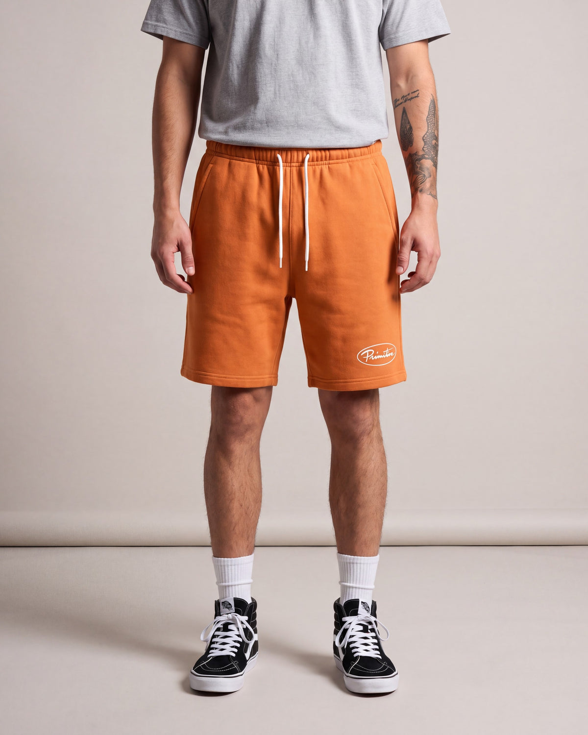 Primitive Luke Script Fleece Shorts — Orange — model front