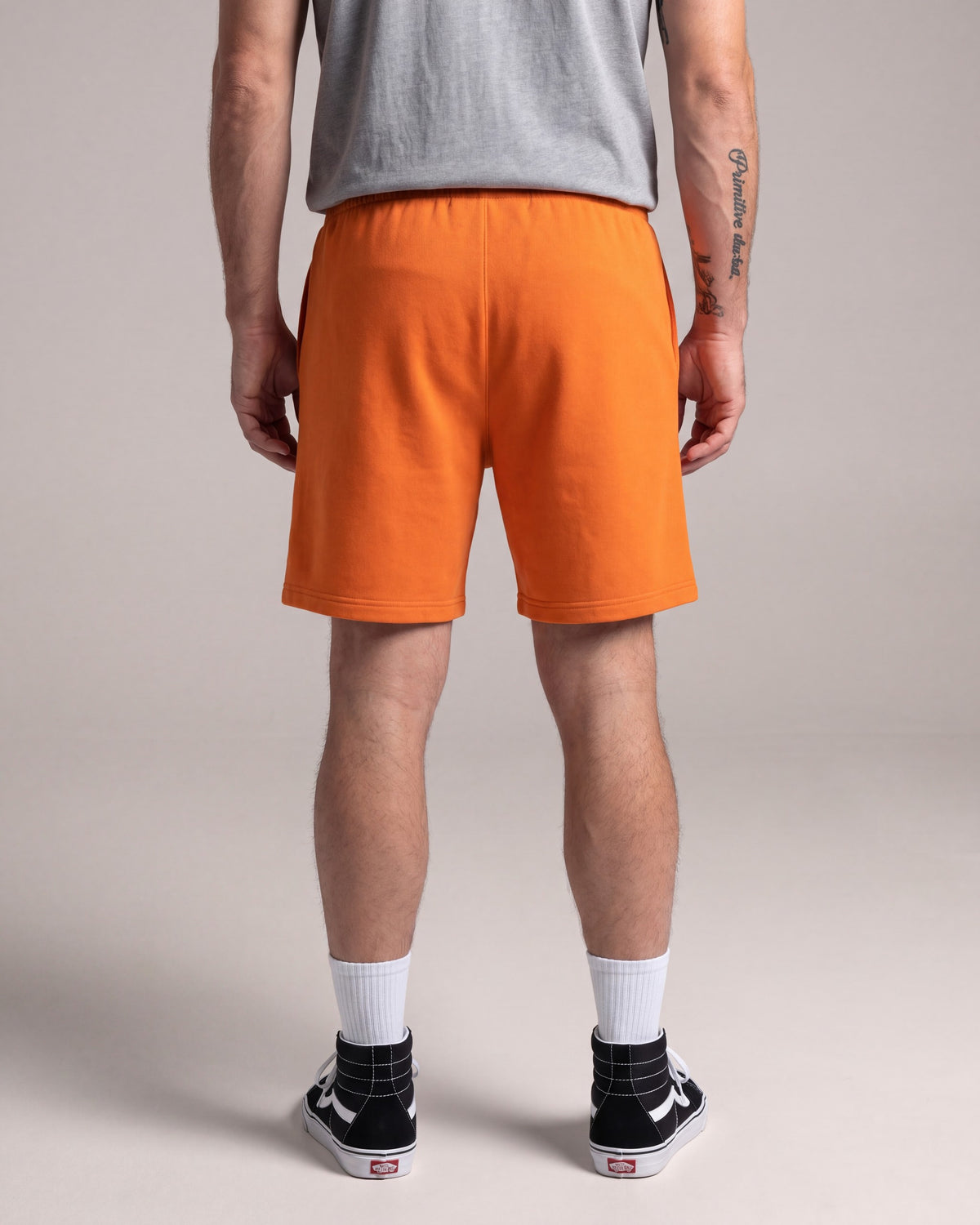 Primitive Luke Script Fleece Shorts — Orange — model back
