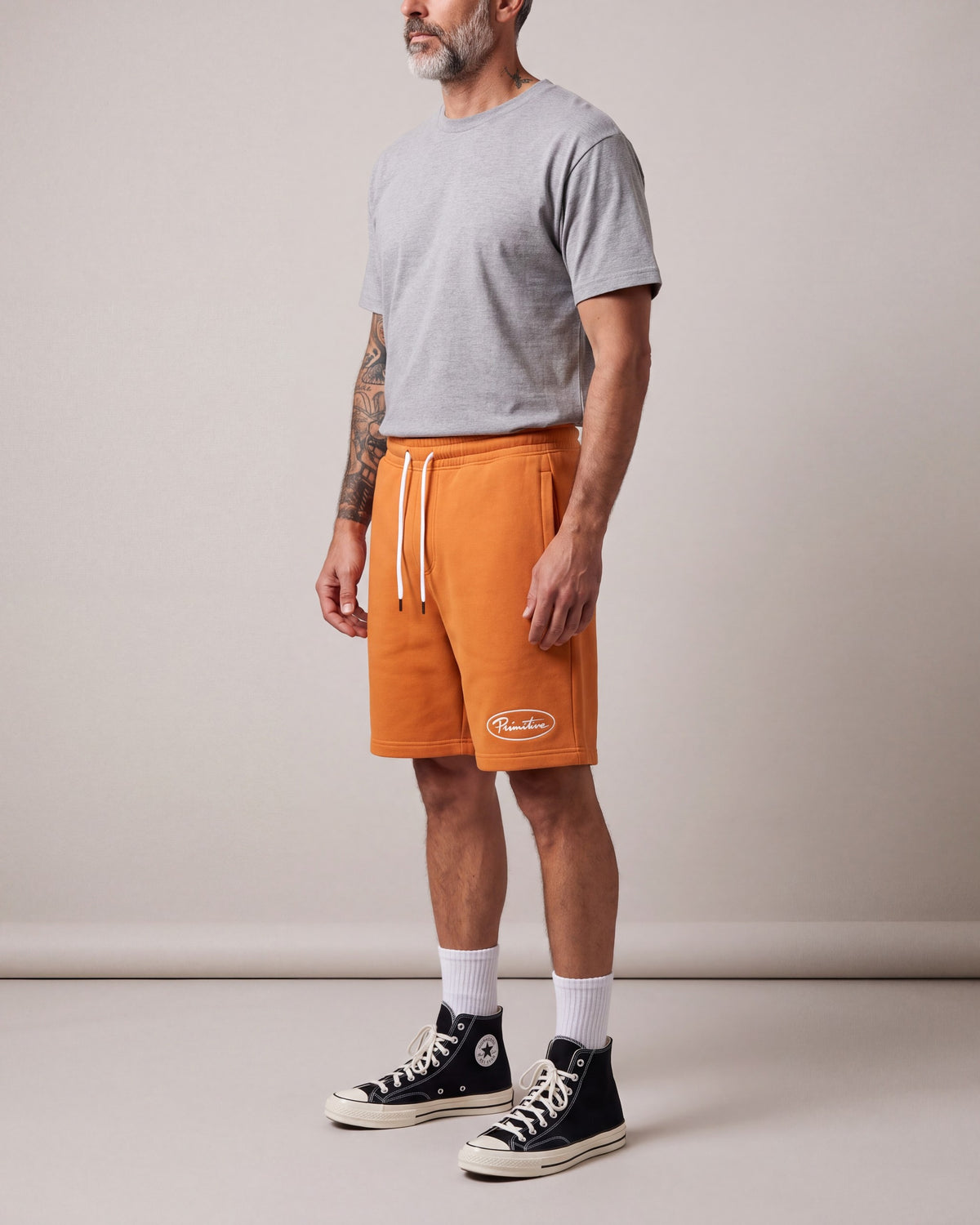 Primitive Luke Script Fleece Shorts — Orange — model side
