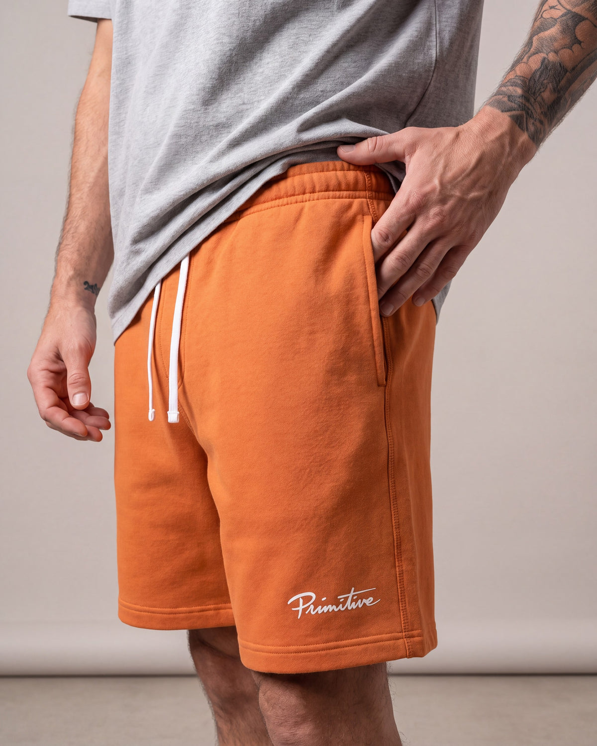 Primitive Luke Script Fleece Shorts — Orange — model detail
